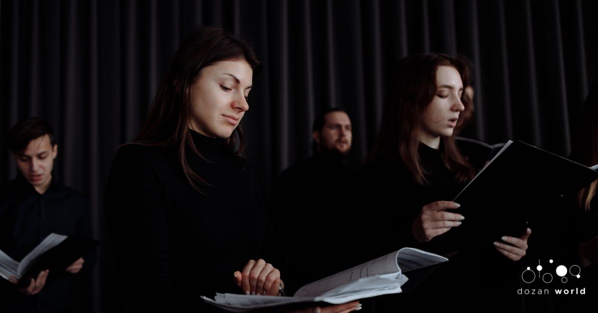 Choir members reading sheet music during a winter concert rehearsal, exploring repertoire beyond traditional Western choral classics.